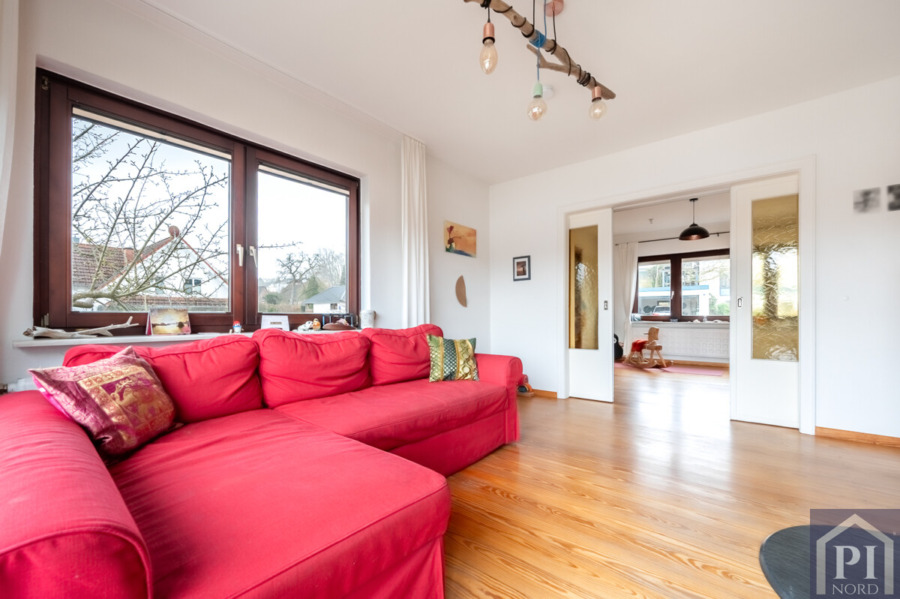 Wohnzimmer mit Schiebetür und Holzfußboden